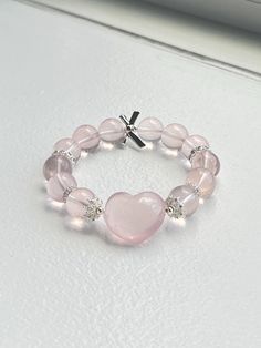 ❤️Add a touch of elegance and tranquility to your jewelry collection with this beautiful Rose Quartz bracelet. Crafted from smooth, round beads, this bracelet captures the gentle pink hue of Rose Quartz, known as the stone of universal love. ▫️Material: Genuine Rose Quartz Round Beads; Heart-shaped Rose Quartz, DIY accessories  ▫️Bead Size: 12mm ▫️Rose quartz heart size: 15mm*10mm ▫️Bracelet length: fits wrist length 15cm (6in)+  ✅Care Instructions: ✔️Keep away from harsh chemicals and prolonged exposure to water. ✔️Clean with a soft cloth to maintain its natural shine. 🔺Please note:  ☑️All photos are taken in the natural daylight with no filter applied. ☑️Each bead in the bracelet is unique. The presence of dark spots, white lines and yellow hues add to the natural beauty of your bracele Rose Quartz Round Beads Jewelry For Valentine's Day, Elegant Heart-shaped Beaded Friendship Bracelets, Valentine's Day Rose Quartz Beaded Jewelry, Elegant Pink Beaded Bracelets With Heart Beads, Elegant Beaded Heart-shaped Stretch Bracelet, Elegant Pink Heart Beaded Bracelets, Elegant Pink Heart-shaped Beaded Bracelets, Rose Quartz Round Beads Bracelet For Valentine's Day, Elegant Rose Quartz Stretch Bracelet With Round Beads