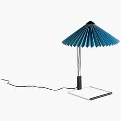 an electronic device is plugged into a lamp that looks like a folded paper umbrella