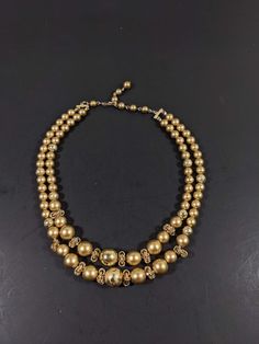 This vintage necklace has 2 strands of gold tone beads. It measures 18 inches long with a hook style clasp. It has only very light wear. R Cluster Necklace, Plastic Jewelry, Crystal Necklace Pendant, Multi Strand Necklace, Rhinestone Necklace, Minimalist Necklace, Gold Pendant Necklace, Strand Necklace, Boho Necklace