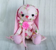 a pink stuffed animal with flowers on it