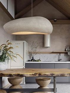 a kitchen with an island table and stools in front of the counter top that is made out of concrete