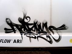 graffiti written on the side of a white vehicle