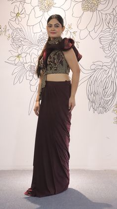 Its a stunning floor-length outfit made from Lycra fabric in an elegant Burgundy color. It features One Side Shoulder. It is embellished with intricate work including Cutdana, Sequins, and Stonework, making it a beautiful choice for special occasions and events. Complete the look by wearing Stone jewelry and bracelet. There might be little color variations in the image and original product due to photographic lightings or your monitor settings. Style: Gown Fabric: Lycra, Net Work: Stonework, Seq Sequence Blouse, Indo Western Gown, Saree Petticoat, Full Sleeve Blouse, Saree Jewellery, Ready To Wear Saree, Lehenga Skirt, Half Sleeve Blouse, Lehenga Saree