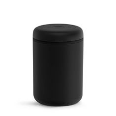 a black canister sitting on top of a white surface