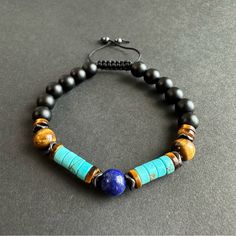 This Beautiful Bracelet Is A Combination Of Matte Black Onyx, Turquoise, Brown Tigers Eye And Centered With Lapis Lazuli And Accented White Black Hematite. All Those Beads Make The Most Powerful Protection Bracelet You Will Have. All Natural Gemstone 8mm Lapis, Onyx And Tigers Eye, 6mm Hematite And Turquoise. Adjustable Blue Bracelets With Black Beads, Adjustable Blue Beaded Bracelets With Black Beads, Adjustable Blue Beaded Bracelets With Natural Stones, Bohemian Blue And Black Beaded Bracelets, Bracelets Men, Turquoise Bead Bracelet, Wood Bracelet, Beads Bracelet Design, Spike Earrings