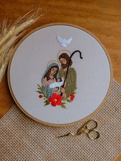 a cross stitching project with scissors on a table