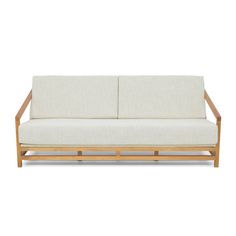 a white couch sitting on top of a wooden frame