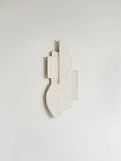 a piece of white paper that has been cut in half and is on the wall