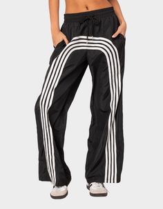 These Nylon Track Pants Offer Both Style And Comfort, Making Them Perfect For A Sporty Yet Fashionable Look. They're Ideal For Any Activity, Ensuring You Feel Comfortable And Confident Throughout Your Entire Day. Track Pants. Contrasting Stripes. Adjustable Tie Waist. Oversized Fit. Nylon Fabric. 100% Polyester. Model Wears Size S. Model Height Is 5'9. Item Care: Wash With Similar Color. | Edikted Wilda Striped Nylon Track Pants Track Pants For Women, Miami Trip, Nylon Track Pants, Flannel Sweatshirt, Fav Quotes, Open Knit Sweater, Cargo Skirt, Nylon Fabric, Sweaters And Jeans