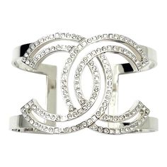 Chanel Classic Silver CC Square Round Crystal Cutout Double Cuff Bracelet  *Marked 17 *Made in Italy *Comes with the original box and pouch  -Approximately 1.5″ width, 6″ circumference( without the gap), 1.25″ open gap -Very stylish and classic -In a pristine condition  AB4157-00318  Please see the measurements section for best approximate dimensions. Luxury Evening Cuff Bangle, Luxury Cuff Bangle For Evening, Luxury Silver Open Cuff Bracelets, Luxury Silver Open Cuff Bracelet, Luxury Open Cuff Bracelets, Luxury Open Cuff Bracelet As Gift, Designer Cuff Bracelet For Parties, Luxury Cuff Bracelet For Parties, Luxury Cuff Bangle Bracelet For Party