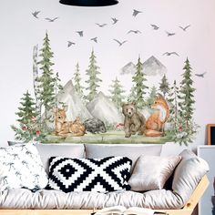 a living room filled with lots of furniture and wallpaper covered in forest animals on it