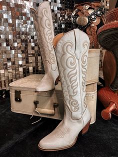 Embrace effortless Western elegance with these breathtaking boots. Crafted from buttery-soft suede in a dreamy, cloud taupe hue, they feature exquisite Western embroidery that adds a touch of authentic charm to the smooth, supple surface. The classic cowboy boot silhouette, with its pointed toe and stacked heel, provides both style and comfort. Perfect for dressing up or down, these versatile boots will become a go-to in your footwear collection. Express your awesome Western-inspired fashionista White Boots For Western-themed Events, Cream Boots For Western-themed Spring Events, Cream Boots For Spring Western-themed Events, Chic Leather Boots For Western-themed Events, Elegant Snip Toe Boots For Western-themed Events, Elegant Snip Toe Boots For Rodeo, Cream Western Boots For Fall, Western Cream Boots For Ranch, Elegant Fitted Boots For Ranch