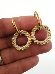 Miyuki Beaded Gold Hoop Earrings Discover the glamour and timeless elegance with these earrings in high quality stainless steel, decorated with a ring woven in Miyuki beads, handmade.  The earrings I make with Miyuki beads can be customized with the color of your choice, do not hesitate to contact me for more information. Description of the earrings Hand woven Miyuki beads 20mm Stainless steel oval hoop earring 16x13mm To see the whole collection, click here: https://www.etsy.com/shop/AQBijouter Metal Hoop Beaded Earrings For Pierced Ears, Beaded Metal Hoop Earrings, Metal Hoop Beaded Earrings, Gold Beaded Metal Hoop Earrings As Gift, Round Metal Earrings With Gold Beads, Beaded Small Hoop Earrings In Metal, Metal Hoop Beaded Earrings As Gift, Elegant Nickel Free Hoop Beaded Earrings, Elegant Metal Beaded Hoop Earrings