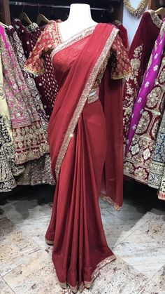 Maroon embroidered saree with stones. Stitched blouses, Peticoat and Fall Beeding included! Blouse style is same for entire order. Blouses are stitched to individual measurements but the shape of the neckline needs to be the same. For example- If you choose a sweetheart neckline all bridesmaids will have a sweetheart neckline but one bridesmaids can have the depth to be 8inches vs. the other can ask the neckline to be 10inches. Final fittings/alterations not included. Fabric - Georgette Our brid Traditional Chinon Blouse With Dupatta, Traditional Drape Blouse With Dupatta In Chinon, Traditional Saree With Mirror Work For Reception, Designer Wear Traditional Drape Blouse With Dupatta, Traditional Drape Blouse With Mirror Work, Diwali Reception Blouse Piece With Mirror Work, Traditional Drape Georgette Blouse With Zari Work, Traditional Drape Blouse With Resham Embroidery, Designer Kundan Saree