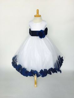 a white and blue flower girl dress on a mannequin