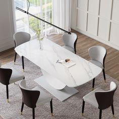 a white table with chairs around it in a room