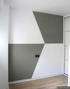 an empty room with white and grey walls