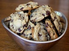 a metal bowl filled with chocolate chip cookies