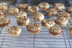 many small pastries are cooling on a rack