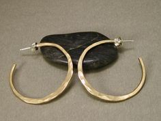 These gold filled hoop earrings are made from 12 gauge wire, so they're strong and have a lot of substance to them. They've  have been hand shaped and hammered individually, and then tumbled for strength and polished for a high shine. Sterling posts and ear nuts give it  that continuous flow and a secure fit to the ear lobe. A classic look that never goes out of style.  Made to order, so allow 10 working days for fabrication.  I always have some of these in stock, so check with me for available Metalsmith Jewelry, Metalsmithing Jewelry, Hammered Earrings, Gold Filled Hoops, 12 Gauge, Hand Shapes, Gold Hoops, Jewelry Earrings Hoops, Jewelry Gold