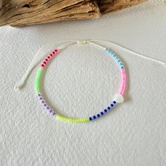 - Elevate your summer and festival wardrobes with this meticulously handcrafted anklet, designed to bring joy and color to your every step. Made with a vibrant selection of Miyuki beads in hues of blue, neon pink, navy, sky blue, neon yellow, purple, clear, green, and red, this anklet embodies the spirit of summer and celebration. - At the heart of this unique piece is a delicate, heart-shaped shell charm, symbolizing love and the beauty of nature. The adjustable design ensures a perfect fit for Colorful Beaded Friendship Bracelets For The Beach, Colorful Beaded Anklets For Spring Gift, Pink Beaded Bracelets For Spring Festival, Spring Gift Anklets With Colorful Beads, Multicolor Tiny Beads Bracelets For Beach Season, Multicolor Tiny Beads Bracelet For Beach Season, Spring Beach Bracelets With Tiny Beads, Bohemian Summer Friendship Bracelets With Round Beads, Adjustable Rainbow Beaded Bracelets For Spring