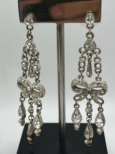 "Vintage elegant chandelier shape  earrings.Silver  tone metal clear glass crystals seeded pearls  Not singed Measures 2 3/4\"x 3/4\" In very good vintage condition. Please keep mind each electronic device has different resolution, brightness and clarity. Therefore products might have slight difference of shade/tone/color in person. Please see my other listings and thanks for shopping." Cheap Vintage Silver Chandelier Earrings, Silver Pearl Drop Clip-on Earrings For Evening, Vintage Chandelier Dangle Earrings For Anniversary, Vintage Dangle Chandelier Earrings For Anniversary, Elegant Metal Earrings For Vintage Events, Silver Teardrop Earrings With Pearl Drop For Party, Silver Crystal Chandelier Earrings For Anniversary, Glamorous Silver Bridal Earrings With Rhinestones, Silver Bridal Earrings With Bling For Wedding