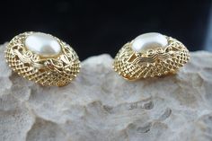 This is the perfect option for those who like cool, unique jewelry and the luxury, shine of gold and white. This earrings are well made, cute and/or elegant in design, and very desirable. The earrings are decorated with faux pearls. The earrings have filigree design. The clasp is in very good working condition. ♥ Age/era: Circa 1950s - 1960s. ♥ There is no hallmark. ♥ The earrings are about 1'' by 3/4''. Every one interested in the jewelry should remember that he or she must like their jewelry- Gold Pierced Pearl Earrings For Party, Elegant Yellow Gold Metal Clip-on Earrings, Gold Metal Pearl Earrings For Anniversary, Elegant Gold-tone Jewelry With Filigree, Elegant Gold-tone Filigree Jewelry, Classic Gold Metal Pearl Earrings, Pierced Metal Pearl Earrings For Anniversary, Ornate Gold Clip-on Jewelry, Elegant Gold-tone Pearl Earrings With Pierced Ears