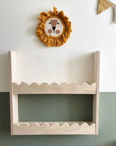 a wall mounted shelf with a lion head on it