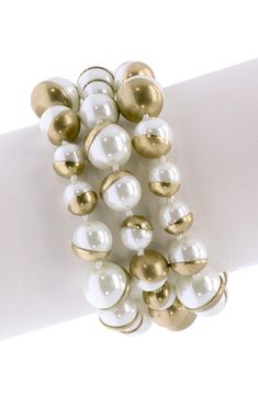 Refined, elegant freshwater pearls add a sophisticated style for a three tiered bracelet. Gold plated base metal freshwater pearl three layer bracelet. Magnetic clasp closure.  Approx. 7.75" x 1.5". Approx. 8mm-10mm-12mm pearl size. Imported Pearl Bracelet With Spacer Beads, Elegant Pearl White Necklace With Spacer Beads, Elegant White Pearl Bracelet With Extender, Elegant White Pearl Metal Bracelet, Party Pearl Drop Bracelet With Round Beads, Pearl White Round Bead Bracelets, Elegant White Pearl Bracelet With Spacer Beads, Pearl White Pearl Beaded Bracelets, Pearl White Pearl Bracelets