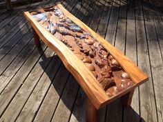 a wooden bench sitting on top of a wooden deck