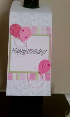 a birthday card with two pink buttons on it