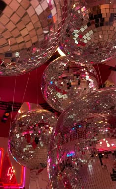 several disco balls hanging from the ceiling in a room