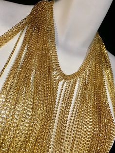 Love this necklace! Gold plated Strands of long champagne colored crystals. Can be worn as a necklace or choker. Always remember more is more! Glamorous Gold Body Chain For Evening, Gold Crystal Backdrop Necklace For Party, Gold Body Chain For Parties, Gold Rhinestone Backdrop Necklace For Party, Gold Body Chain With Adjustable Chain For Party, Gold Adjustable Body Chain For Party, Glamorous Gold Body Chain With Adjustable Chain, Glamorous Gold Adjustable Body Chain, Elegant Gold Crystal Body Chain