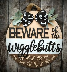 a wooden sign that says beware of the wigglebutts