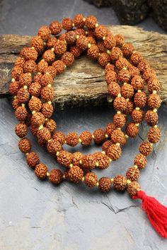 This simple hand-crafted mala featuring a deep red tassel, is made of 108 knotted Rudraksha seed beads and is perfect for your everyday ritual and mediation. Legend has it that the first Rudraksha seeds were created from tears of Lord Shiva as they fell on the earth and formed into a tree. Rudraksha seeds have wonderful spiritual and medicinal properties and, you can feel their power as you count through the beads one by one to recite your chosen mantra or intention. The number 108 holds spiritu Tibetan Yak, Rare Beads, Rudraksha Mala, Powerful Prayers, Mala Meditation, 108 Bead, Bone Beads, Beads Handmade, Lord Shiva