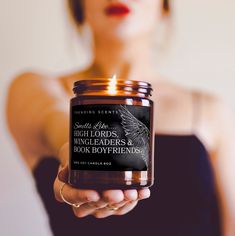 a woman holding a candle in her hand with the words high lord's, wingleaders and book boyfriends written on it