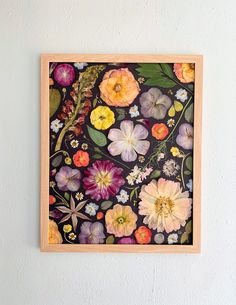 an image of a painting on the wall with flowers in it and leaves around it