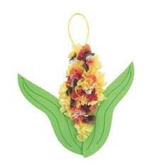 an ornament shaped like a flower with leaves and flowers on it's side