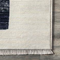 an area rug with fringes on the bottom and blue, white and grey colors