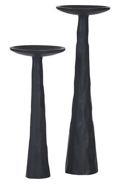 two tall black vases sitting next to each other