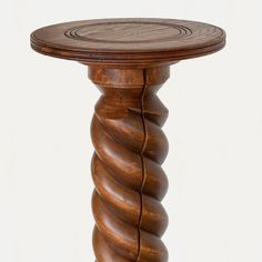 a round wooden table with spiral design on top