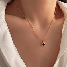 Indulge in refined elegance with our exquisite Minimalist Heart Black Onyx Necklace, a captivating fusion of style and grace. This darling gold heart necklace boasts a dainty design, featuring a petite pendant adorned with a captivating black onyx stone, effortlessly exuding sophistication. Its delicate size adds a charming touch, making it the epitome of a cute necklace for any occasion. Whether as a thoughtful gesture or a personal indulgence, this necklace for women is the perfect gift for he Elegant Heart Necklace With Round Pendant And Adjustable Chain, Elegant Heart Necklace With Adjustable Chain, Trendy Black Heart Necklace With Clavicle Chain, Black Necklace With Delicate Chain And Round Pendant, Black Clavicle Chain Necklace As Gift, Black Necklace With Adjustable Chain For Valentine's Day, Trendy Black Charm Necklaces For Gifts, Trendy Black Charm Necklace For Gifts, Black Dainty Clavicle Charm Necklaces