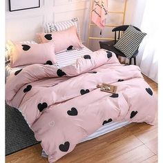 a bed with pink and black hearts on it