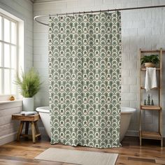 a bath room with a shower curtain and a rug