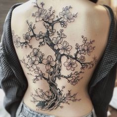 a woman with a tree tattoo on her back