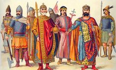 a group of men dressed in medieval clothing standing next to each other with swords and shields