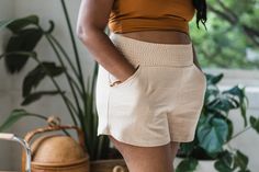 Our Piedra Shorts are made from organic cotton french terry so the fabric has a nice weight feel and durability. The shorts have two front pockets perfect for stashing anything and small pleats on the front and back to give them some shape and structure. The waist belt is made from bobbin elastic creating a stretchy and soft band for your belly. The legs are wide and the crotch is low, making these shorts super comfortable and perfect for many adventures. They are available in 4 French Terry col Cotton Loungewear Bottoms With Waistband, Loungewear High-waisted Shorts With Side Pockets, Relaxed Beige Shorts With Elastic Waistband, Solid Color Bottoms With Elastic Waistband In Organic Cotton, Beige Relaxed Fit Shorts With Elastic Waistband, High-waisted Bermuda Shorts With Pockets For Loungewear, Organic Cotton Summer Shorts For Everyday Wear, Organic Cotton Shorts For Everyday Summer Wear, Everyday Organic Cotton Bottoms With Pockets