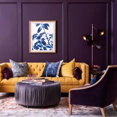 a living room with purple walls and yellow couches