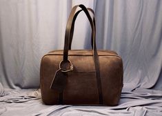 "Elevate your travel style with our exquisite Handcrafted Leather Travel Overnight Bag a fusion of elegance, durability, and wanderlust. This leather bag has a unique style of long handles that make this bag more stylish and easy to carry. LEATHER COLOUR: DARKEST BROWN CRUNCH Size: 18\"x12\"x6\"(LxHxW) FREE Personalization on the Leather tag. Key Features: Our artisans handcraft each travel bag with precision and care, resulting in a masterpiece that stands the test of time. Every stitch is a te Custom Duffle Bags, Leather Overnight Bag, Women Christmas Gifts, Mens Weekend Bag, Leather Holdall, Overnight Travel Bag, Leather Duffel Bag, Leather Weekender Bag, Leather Weekender