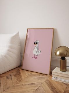 a pink poster with an image of a bird in sunglasses on it next to a lamp